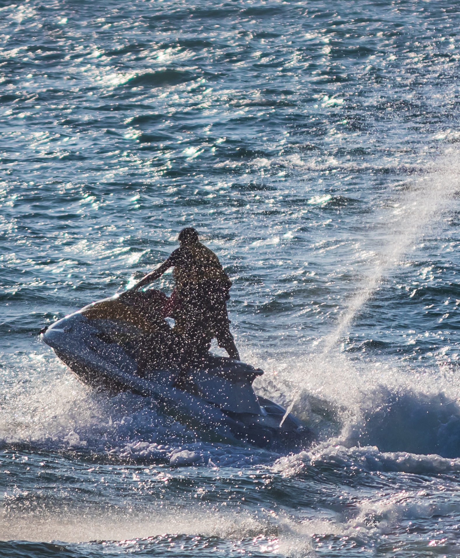 Young people riding a jet ski / wave runner in Goa competing Law Office in Jupiter, FL
