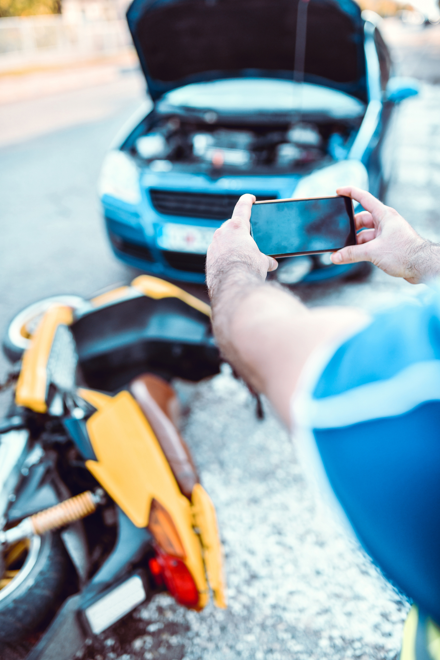 Male Documenting Car And Motorcycle Accident With Photo For Insurance Law Office in Jupiter, FL